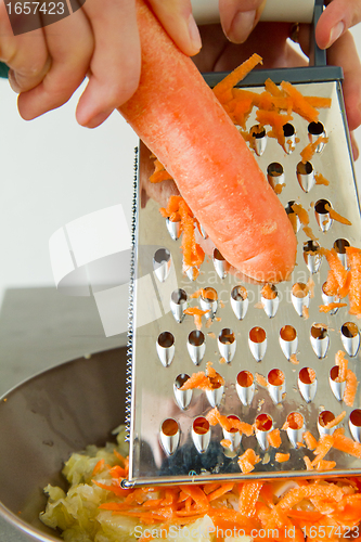 Image of chef grating carrot