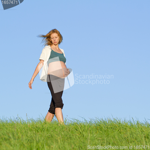 Image of pregnant woman on meadow