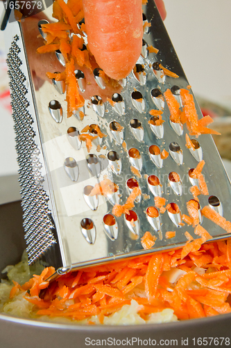 Image of chef grating carrot