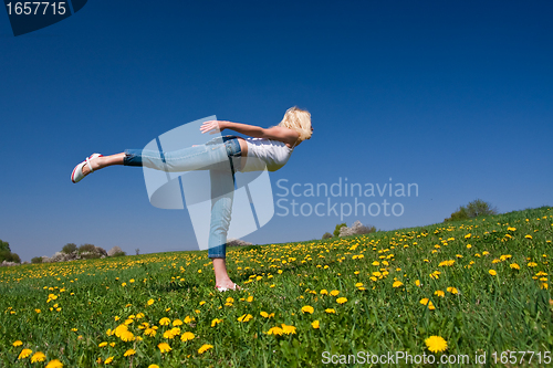 Image of young woman exercising yoga