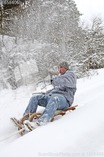 Image of young man goes sleigh in winter