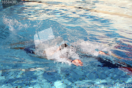 Image of a man swimming backstroke