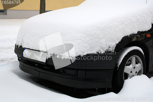 Image of black car covered with snow