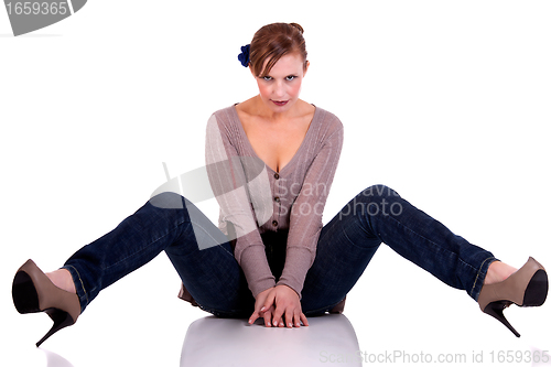 Image of beautiful and happy middle-aged woman, sitting on the floor