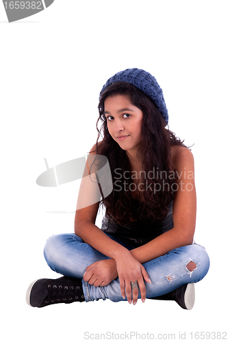 Image of beautiful and happy woman sitting on the floor