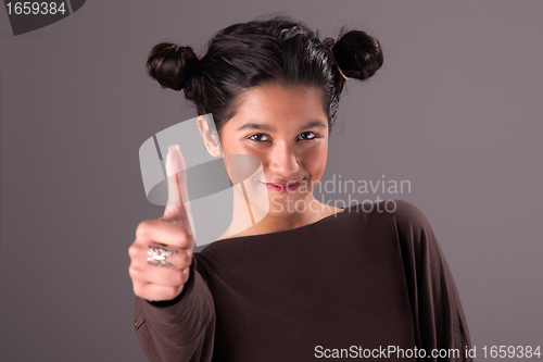 Image of beautiful and happy young woman, with tumb up