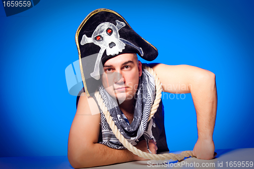 Image of pirate with a cocked hat and a rope on blue