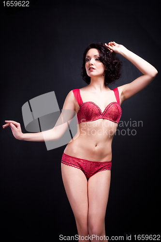 Image of girl in red underwear on black background