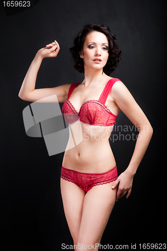 Image of girl in red underwear on black background