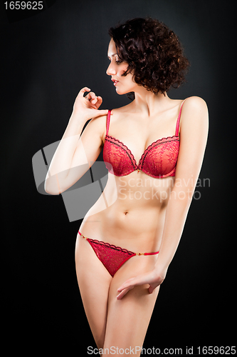 Image of girl in red underwear on black background