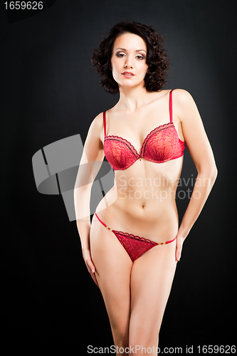 Image of girl in red underwear on black background