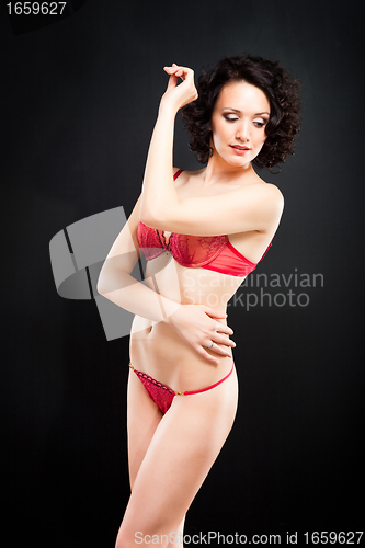 Image of girl in red underwear on black background