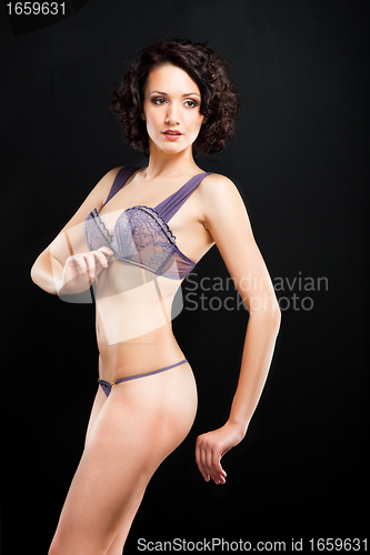 Image of girl in lacy underwear on black background
