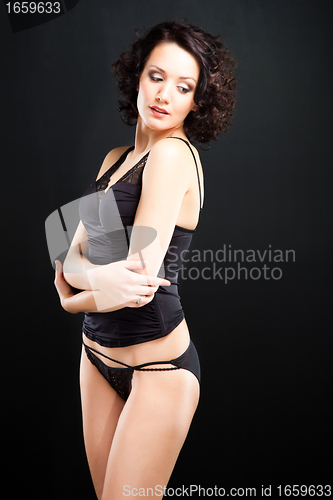 Image of girl in lacy underwear on black background