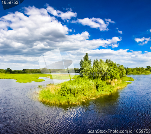 Image of Island with trees on blue cold lake