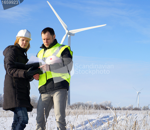 Image of team of  engineers or architects with white safety hat and wind 