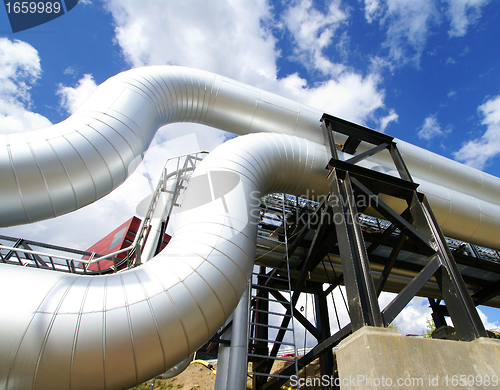 Image of Industrial zone, Steel pipelines and valves against blue sky