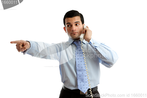 Image of Businessman on telephone pointing