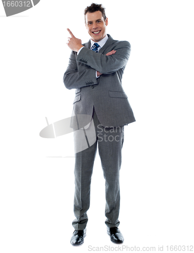 Image of Businessman in suit pointing at copyspace