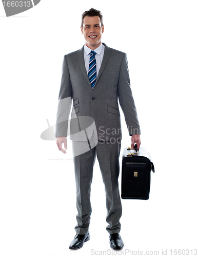 Image of Business executive holding briefcase