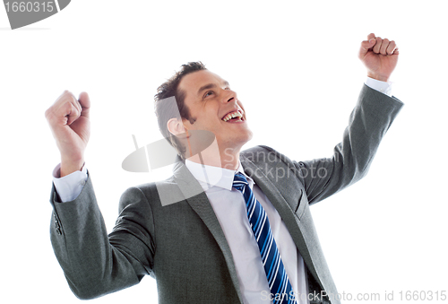 Image of Businessman celebrating success with arms up