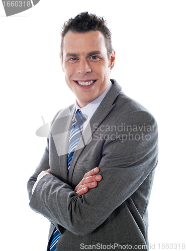 Image of Smiling handsome executive, arms-folded