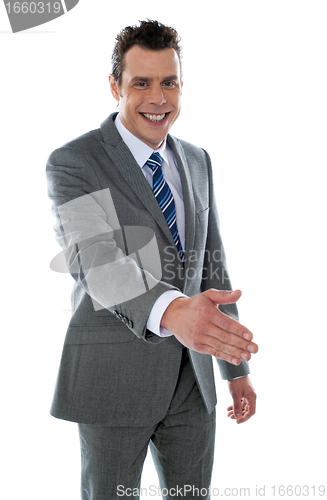 Image of Confident modern businessman offering handshake