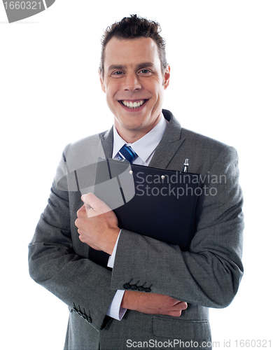 Image of Happy businessman holding a clipboard