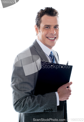 Image of Businessman holding clipboard