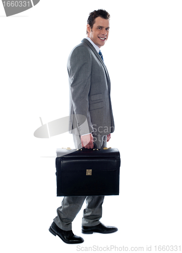 Image of Going business man holding briefcase