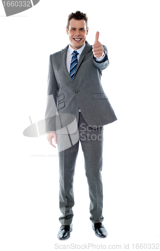 Image of Confident businessman gesturing thumbs up