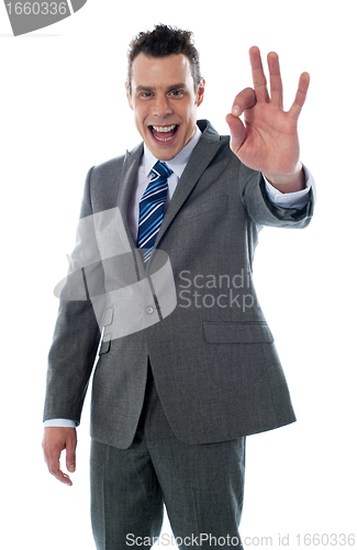 Image of Handsome corporate man gesturing excellent