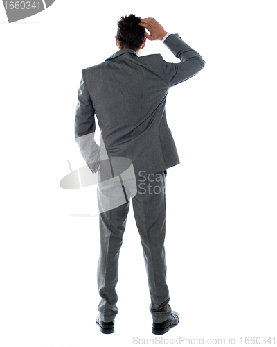 Image of Back-pose of a corporate person thinking