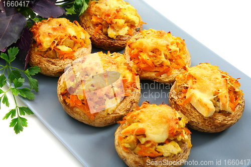 Image of Mushrooms stuffed with vegetables and chicken.