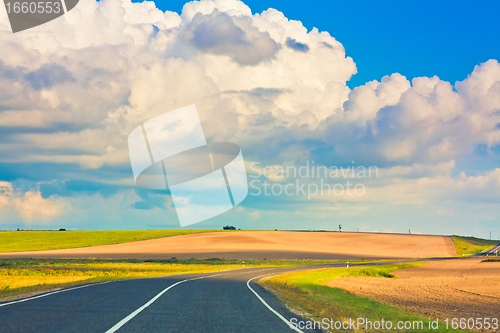 Image of Empty curved road, blue sky
