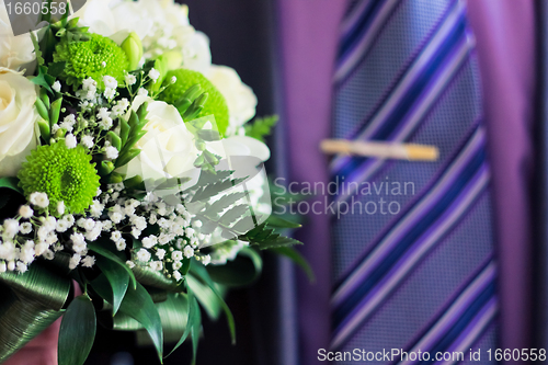 Image of man's hand with white roses