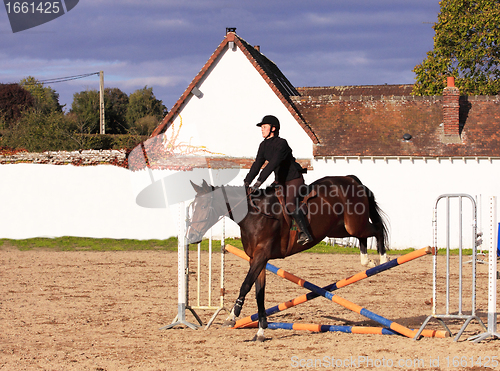 Image of pretty young woman rider in a competition riding