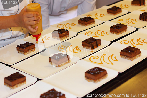 Image of preparation of dessert plates for a chocolate cake louis XV