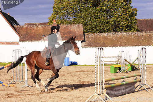 Image of pretty young woman rider in a competition riding