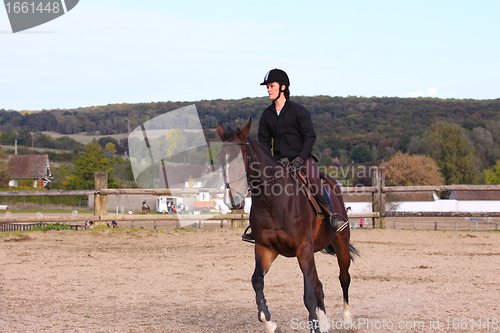 Image of pretty young woman rider in a competition riding