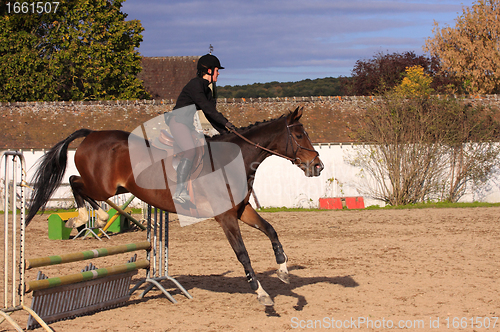 Image of pretty young woman rider in a competition riding