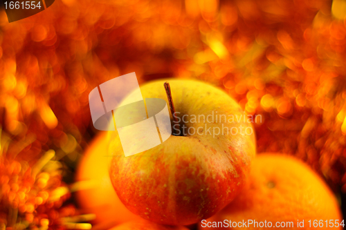Image of apple close-up on a background of twinkling garlands