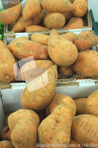 Image of fresh sweet potatoes on a market stall