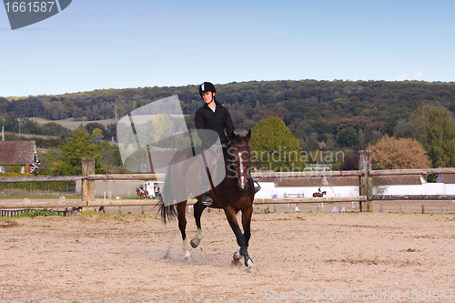 Image of pretty young woman rider in a competition riding