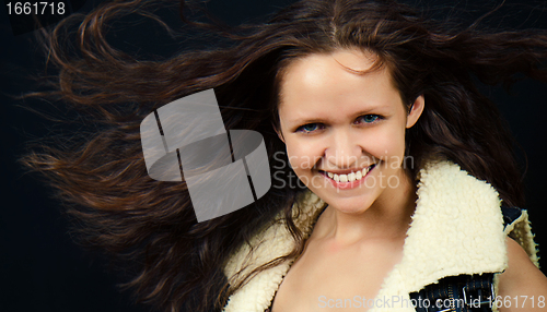 Image of attractive girl with long hair in denim vest