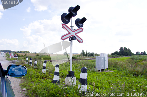 Image of Car stand railway crossing road traffic-light 