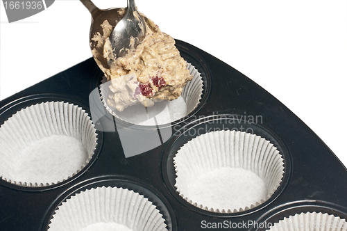 Image of filling a muffin tray