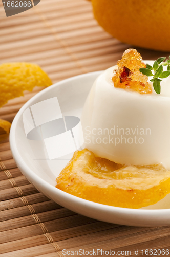 Image of Vanilla Panna Cotta Dessert with lemon and fresh herbs