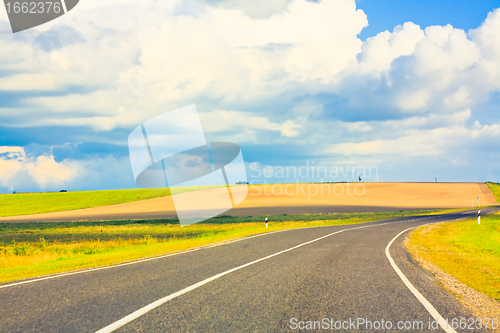 Image of Empty curved road, blue sky