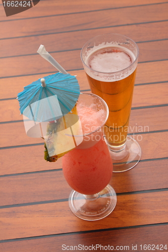 Image of glass of fruit cocktail and a glass of beer